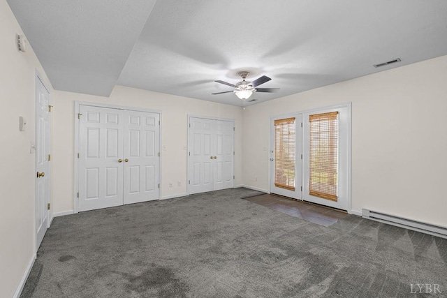 1036 Middle View Dr, Forest, VA 24551 - unfurnished bedroom with carpet, multiple closets, a baseboard heating unit, and a ceiling fan