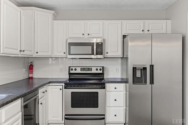 1036 Middle View Dr, Forest, VA 24551 - kitchen with stainless steel appliances, white cabinets, dark countertops, and backsplash