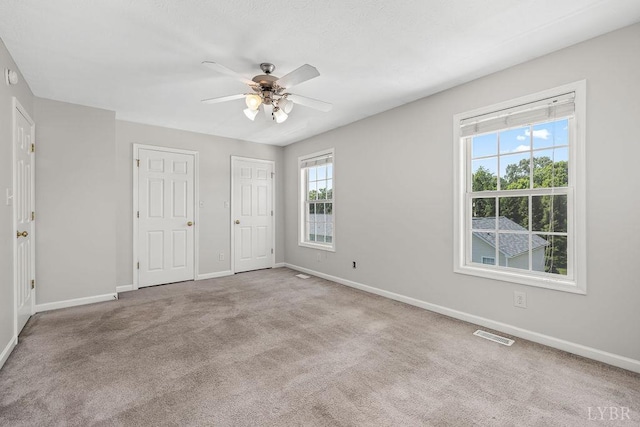 1036 Middle View Dr, Forest, VA 24551 - unfurnished bedroom featuring carpet floors, ceiling fan, and two closets