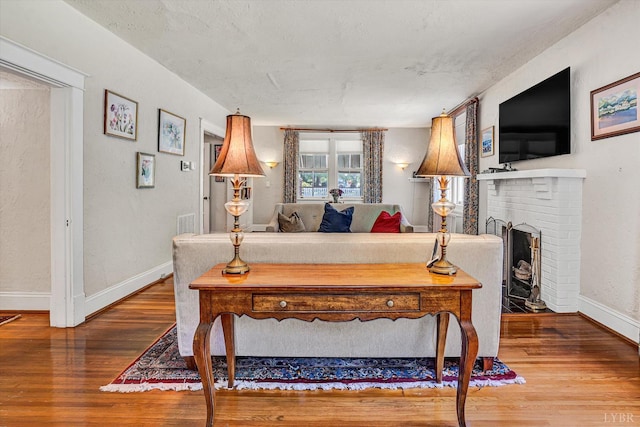 519 Belvedere St, Lynchburg, VA 24503 - living area featuring wood finished floors and a brick fireplace