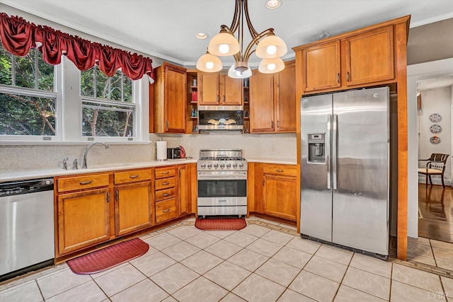 519 Belvedere St, Lynchburg, VA 24503 - kitchen featuring appliances with stainless steel finishes, light countertops, brown cabinetry, crown molding, and recessed lighting