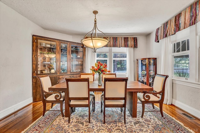 519 Belvedere St, Lynchburg, VA 24503 - dining area with healthy amount of natural light, a textured ceiling, and wood finished floors
