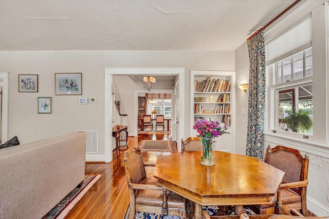 519 Belvedere St, Lynchburg, VA 24503 - dining area featuring a chandelier, wood finished floors, and built in features