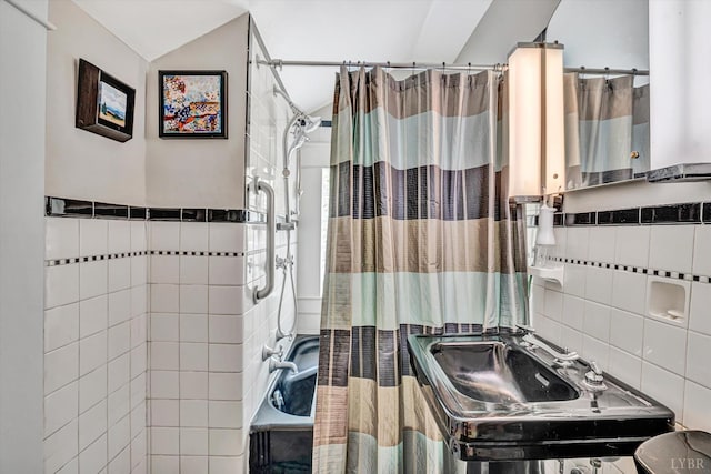 519 Belvedere St, Lynchburg, VA 24503 - bathroom featuring tile walls, shower / bath combination with curtain, and vaulted ceiling