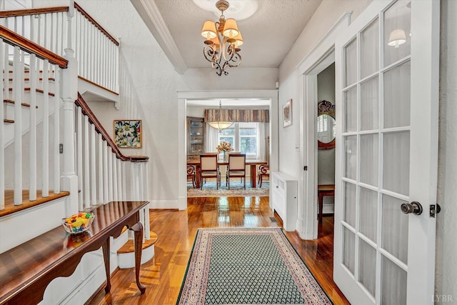 519 Belvedere St, Lynchburg, VA 24503 - entryway with a chandelier, stairs, hardwood / wood-style floors, and a textured ceiling