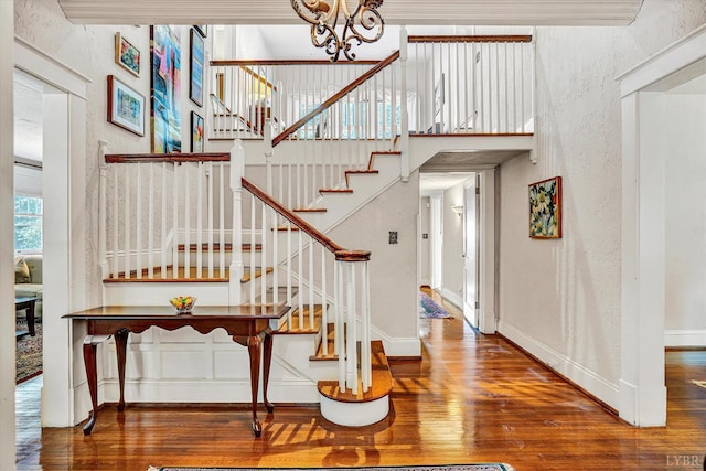 519 Belvedere St, Lynchburg, VA 24503 - staircase with wood finished floors, a chandelier, and a textured wall