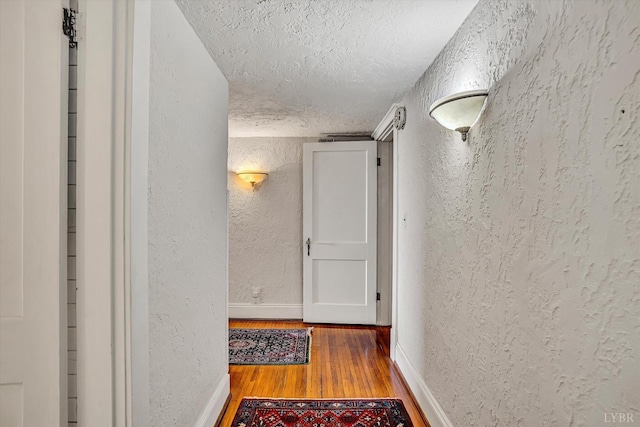 519 Belvedere St, Lynchburg, VA 24503 - hallway featuring a textured wall, a textured ceiling, and wood finished floors