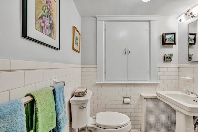 519 Belvedere St, Lynchburg, VA 24503 - half bathroom featuring tile walls and a wainscoted wall