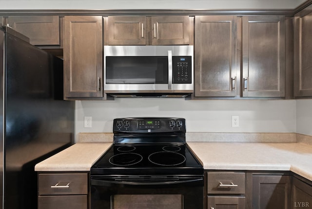 202 Bonterra Pl, Lynchburg, VA 24501 - kitchen featuring stainless steel microwave, electric range, freestanding refrigerator, and light countertops