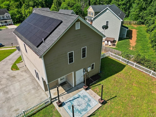 202 Bonterra Pl, Lynchburg, VA 24501 - back of house with roof mounted solar panels, a patio, a shingled roof, and a fenced backyard