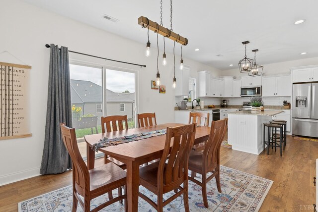 1055 Graystone Ln, Forest, VA 24551 - dining room featuring wood finished floors, recessed lighting, and a chandelier