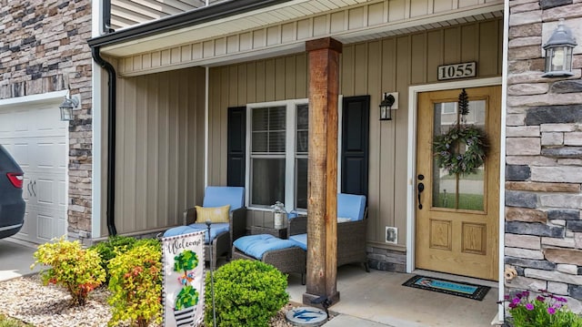 1055 Graystone Ln, Forest, VA 24551 - view of exterior entry featuring stone siding, a porch, and a garage