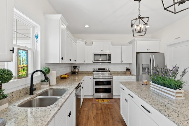 1055 Graystone Ln, Forest, VA 24551 - kitchen with stainless steel appliances, white cabinets, decorative backsplash, decorative light fixtures, and recessed lighting