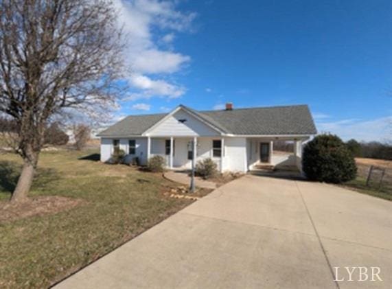 4059 Lowry Rd, Goode, VA 24570 - view of front facade featuring covered porch, driveway, a carport, and a front lawn