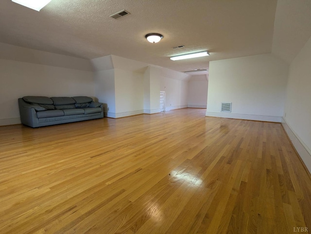 4059 Lowry Rd, Goode, VA 24570 - unfurnished room featuring light wood-style floors, a textured ceiling, and vaulted ceiling