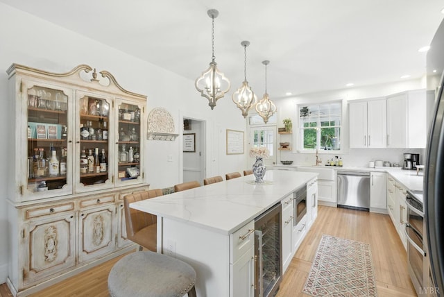 2212 Rivermont Ave, Lynchburg, VA 24503 - kitchen featuring appliances with stainless steel finishes, wine cooler, a chandelier, a center island, and a breakfast bar area