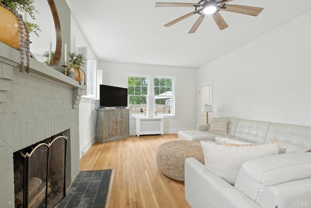 2212 Rivermont Ave, Lynchburg, VA 24503 - living area with radiator, ceiling fan, a fireplace, wood finished floors, and ornamental molding