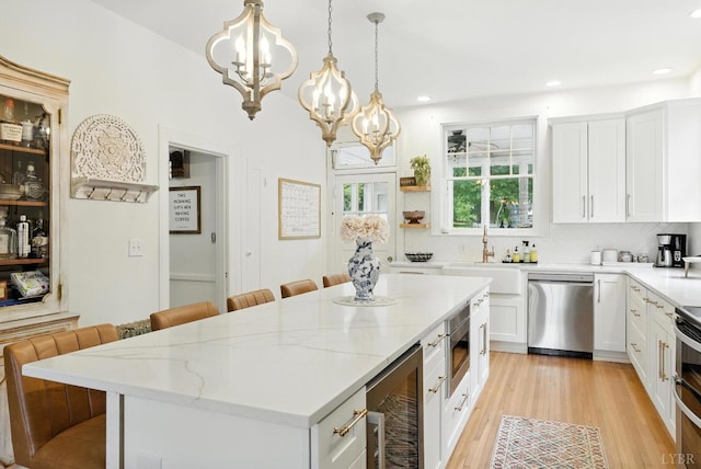 2212 Rivermont Ave, Lynchburg, VA 24503 - kitchen with stainless steel appliances, beverage cooler, a chandelier, a breakfast bar, and recessed lighting