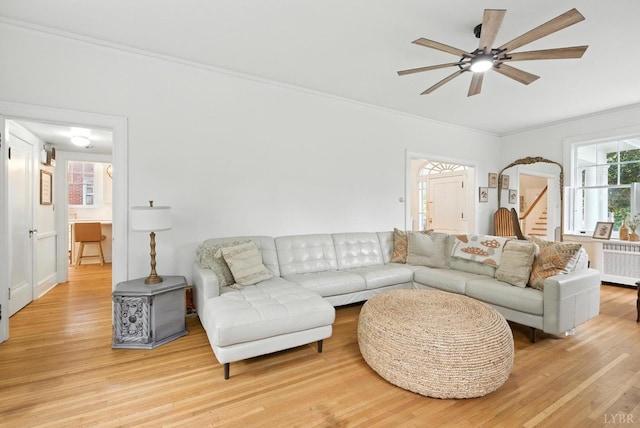 2212 Rivermont Ave, Lynchburg, VA 24503 - living area featuring radiator heating unit, ceiling fan, light wood-style flooring, ornamental molding, and stairs