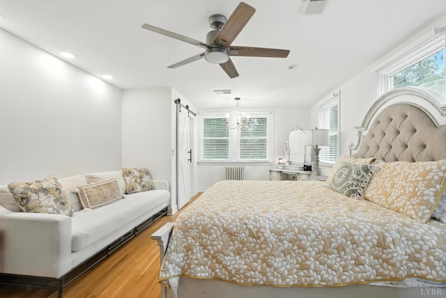 2212 Rivermont Ave, Lynchburg, VA 24503 - bedroom featuring a barn door, wood finished floors, recessed lighting, and a ceiling fan