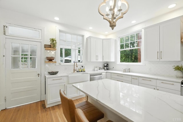 2212 Rivermont Ave, Lynchburg, VA 24503 - kitchen with a chandelier, decorative backsplash, light stone counters, a breakfast bar, and recessed lighting