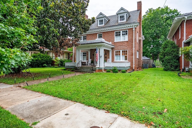 2212 Rivermont Ave, Lynchburg, VA 24503 - colonial house featuring brick siding, a porch, a chimney, a front lawn, and a high end roof