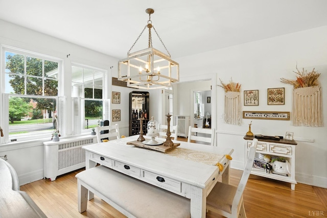 2212 Rivermont Ave, Lynchburg, VA 24503 - dining room featuring radiator, a chandelier, light wood-type flooring, and plenty of natural light