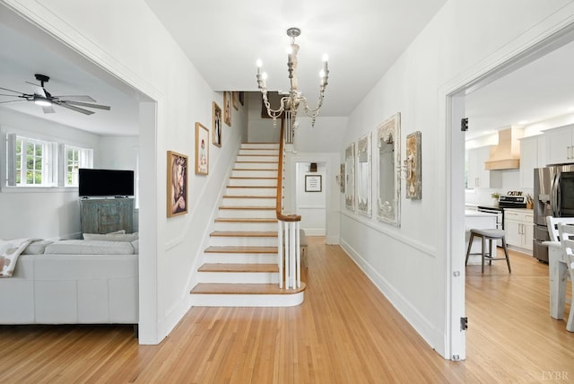 2212 Rivermont Ave, Lynchburg, VA 24503 - staircase with a chandelier, wood finished floors, and a ceiling fan