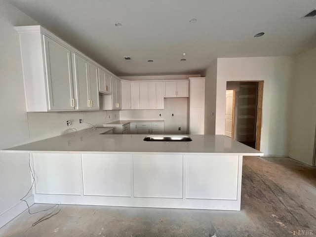 420 Capstone St Unit 107, Lynchburg, VA 24502 - kitchen with a peninsula, white cabinets, and unfinished concrete floors