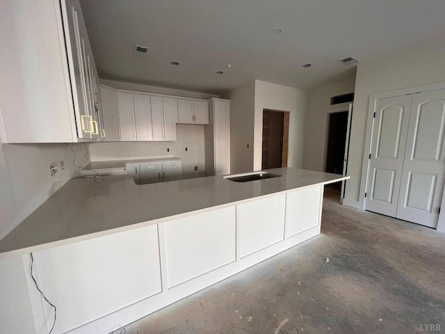 420 Capstone St Unit 107, Lynchburg, VA 24502 - kitchen featuring unfinished concrete floors, a peninsula, white cabinets, and light countertops