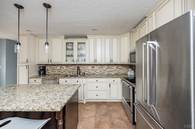 102 Stirling Ct, Forest, VA 24551 - kitchen featuring appliances with stainless steel finishes, cream cabinets, backsplash, light stone countertops, and glass insert cabinets