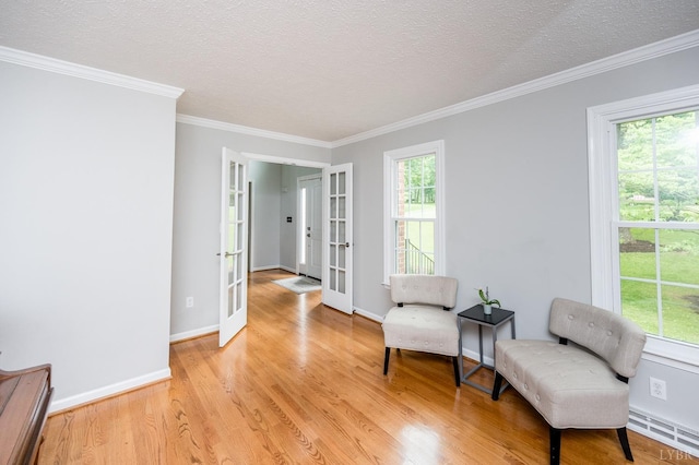 102 Stirling Ct, Forest, VA 24551 - sitting room featuring french doors, light wood finished floors, crown molding, and a textured ceiling
