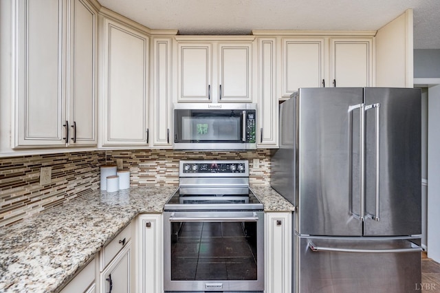 102 Stirling Ct, Forest, VA 24551 - kitchen featuring appliances with stainless steel finishes, cream cabinets, backsplash, and light stone counters