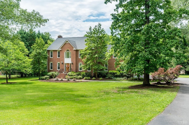 102 Stirling Ct, Forest, VA 24551 - colonial-style house featuring a front yard, a chimney, and brick siding