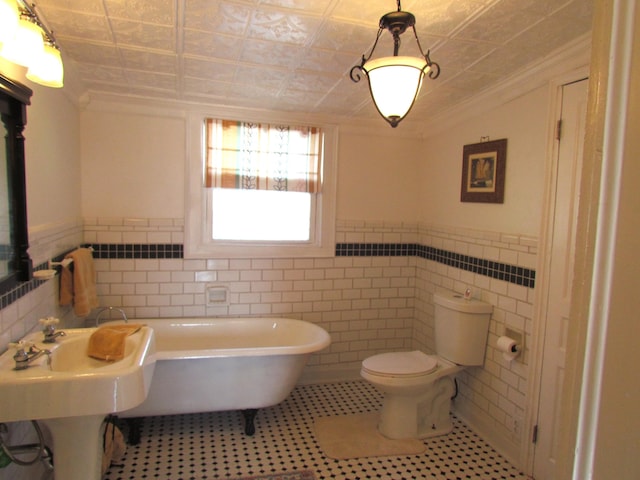740 W 2nd N St, Morristown, TN 37814 - full bathroom with toilet, tile walls, a freestanding bath, wainscoting, and an ornate ceiling
