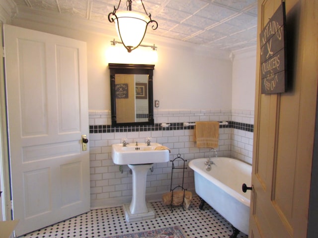 740 W 2nd N St, Morristown, TN 37814 - bathroom with an ornate ceiling, a soaking tub, wainscoting, and tile walls