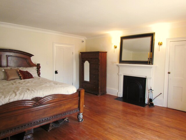 740 W 2nd N St, Morristown, TN 37814 - bedroom featuring a fireplace with flush hearth, ornamental molding, and wood finished floors