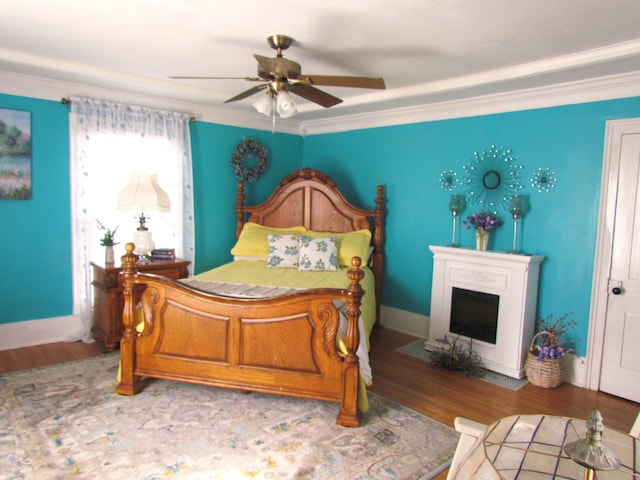 740 W 2nd N St, Morristown, TN 37814 - bedroom featuring a fireplace with flush hearth, a ceiling fan, crown molding, and wood finished floors