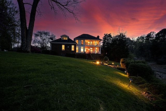 rear view of property with a yard