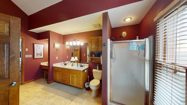 bathroom with toilet, vanity, lofted ceiling, and walk in shower