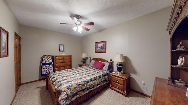 carpeted bedroom with a textured ceiling and ceiling fan