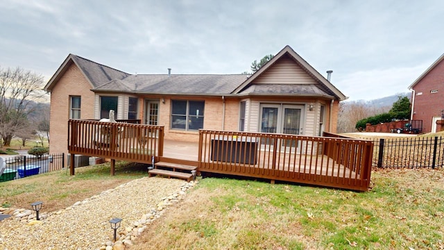 view of front of house featuring a deck and a front lawn