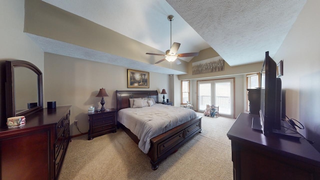 bedroom featuring light carpet, a textured ceiling, vaulted ceiling, and ceiling fan