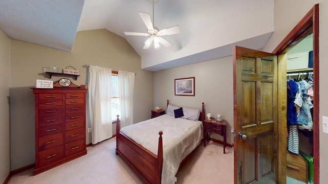 carpeted bedroom featuring ceiling fan and vaulted ceiling