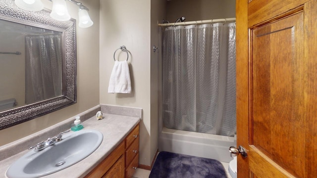 bathroom with toilet, vanity, and a shower with shower curtain