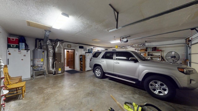 garage featuring white refrigerator, heating unit, a garage door opener, and water heater