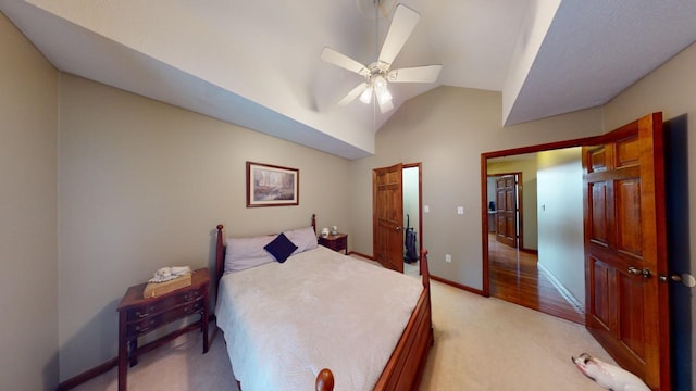 carpeted bedroom featuring ceiling fan and lofted ceiling