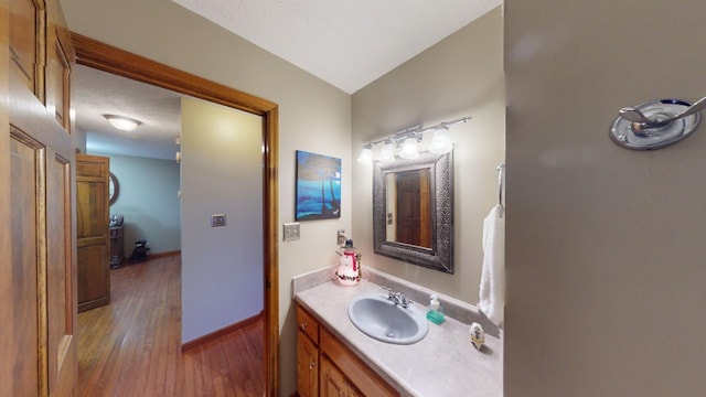 bathroom featuring vanity, a textured ceiling, and hardwood / wood-style flooring