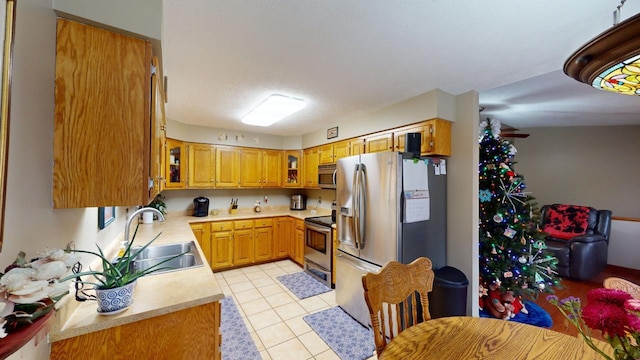 kitchen featuring sink, light tile patterned flooring, and appliances with stainless steel finishes