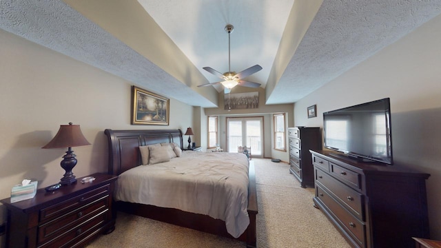 carpeted bedroom with ceiling fan and a textured ceiling